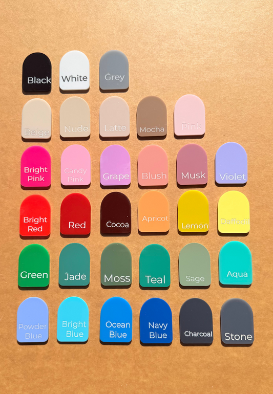 A grid of 30 colour swatches labeled with names like Black, White, Grey, Pink, Red, Green, Blue, and Stone, arranged on a warm tan textured background.